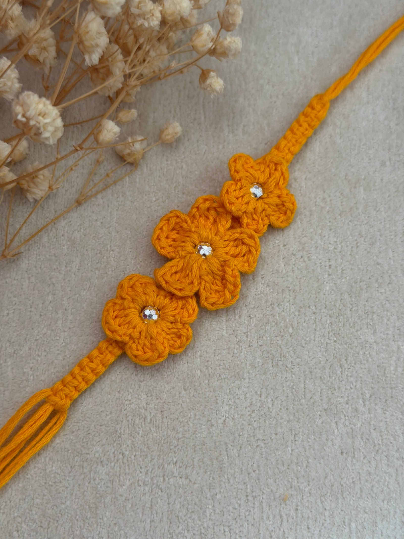 Yellow Crochet Flower Silver Rakhi - Image 2